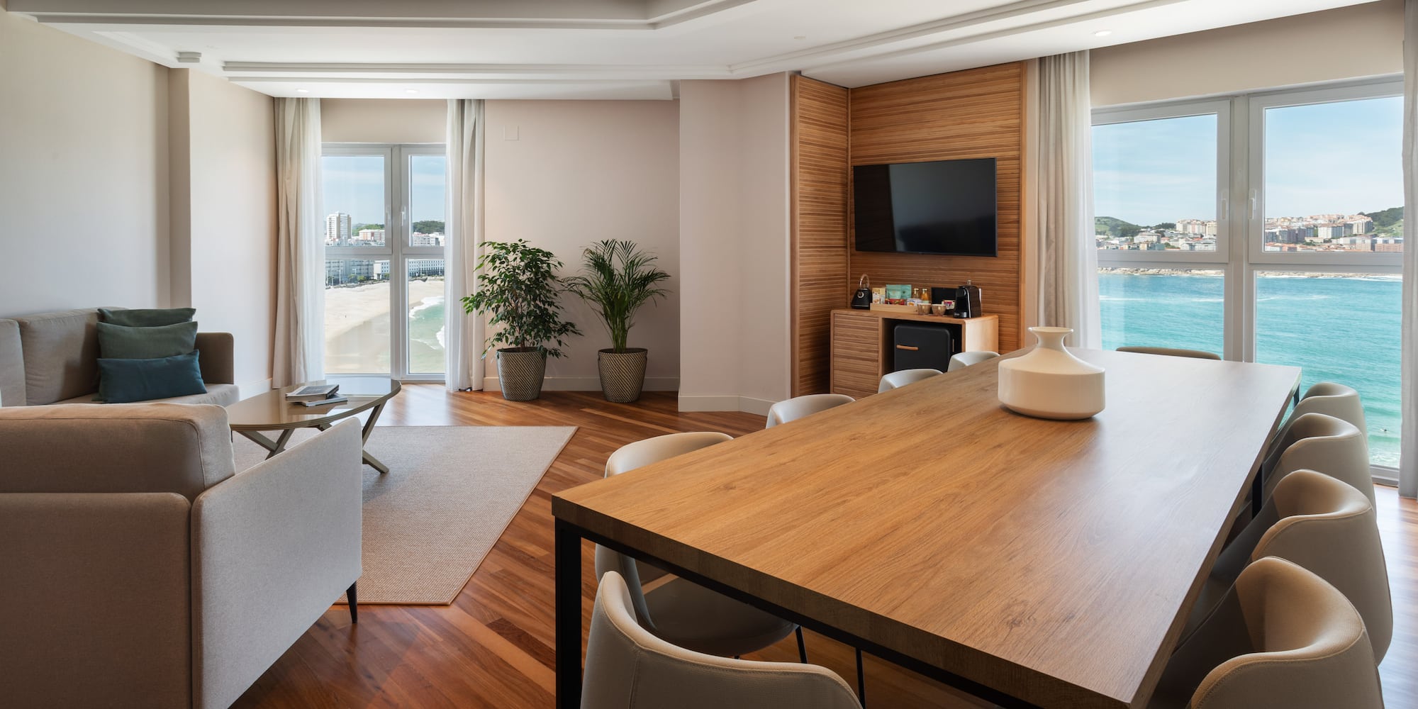 a room with a table and chairs and a television