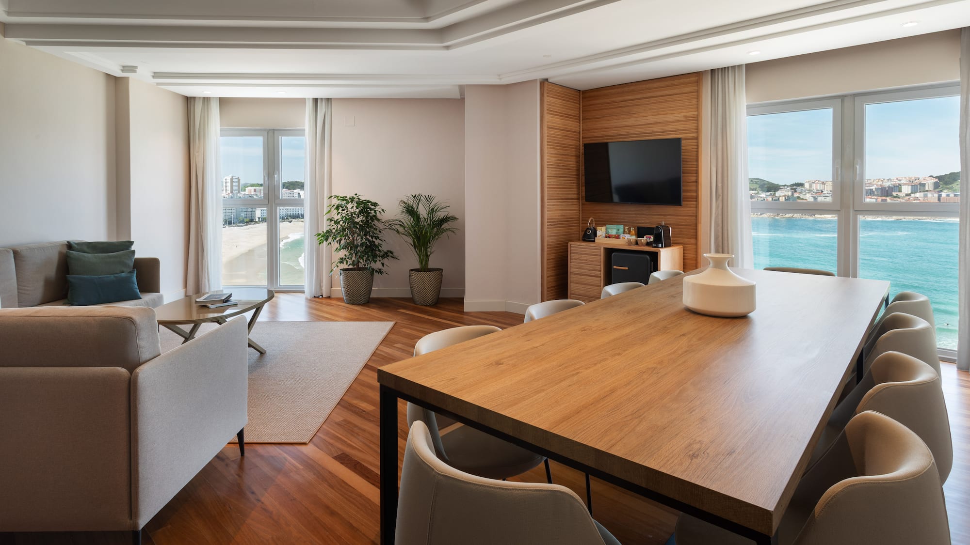 a room with a table and chairs and a television