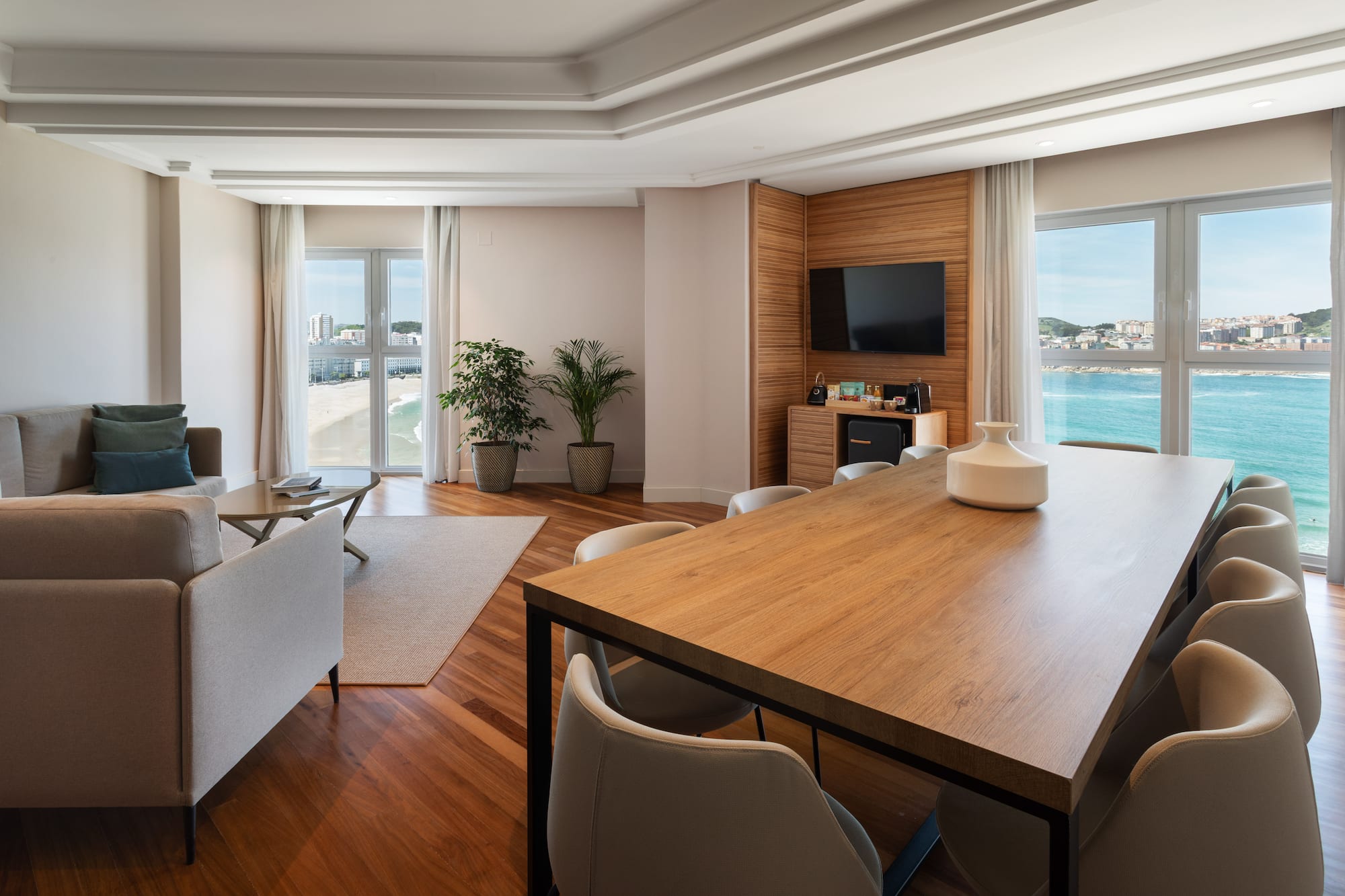 a room with a table and chairs and a television