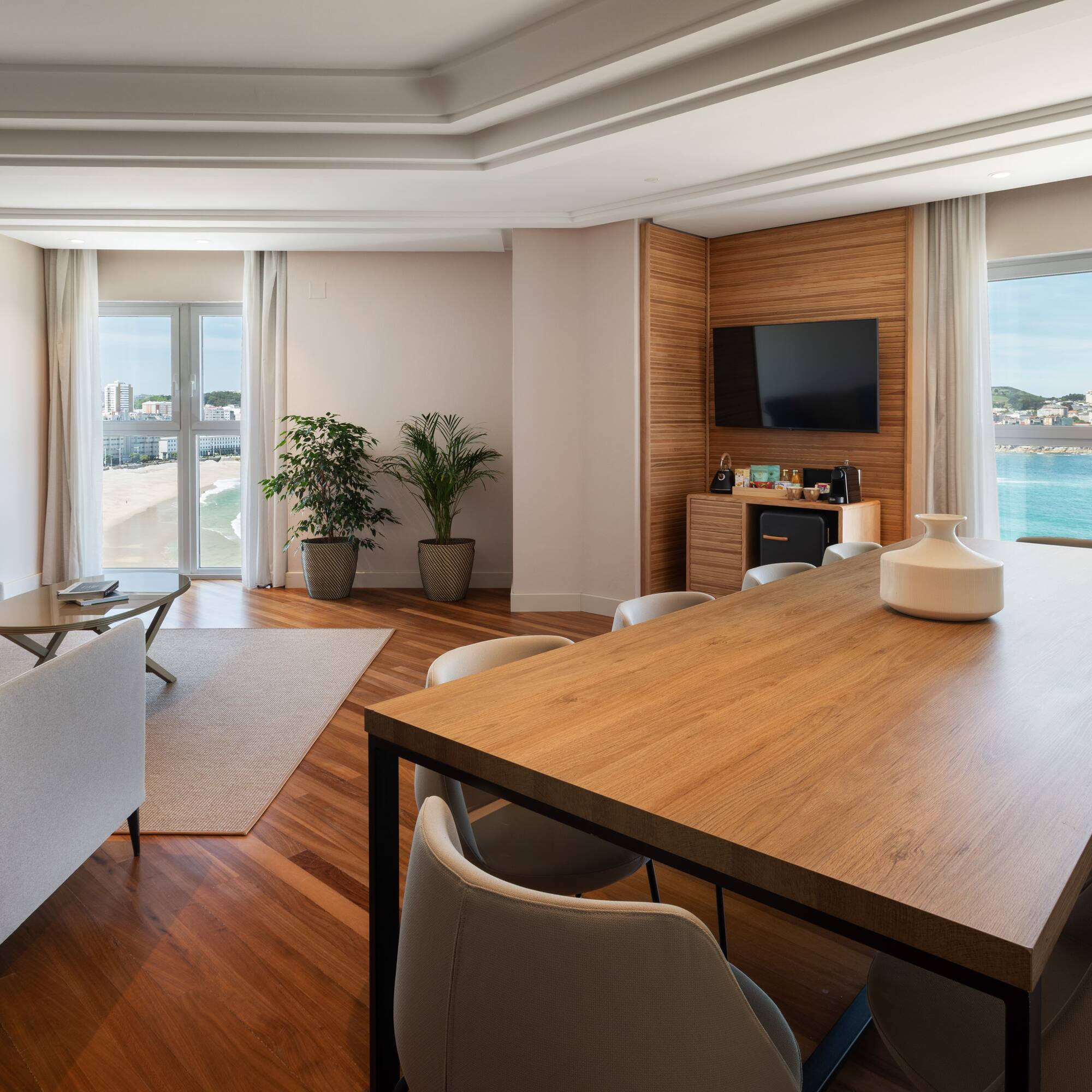 a room with a table and chairs and a television