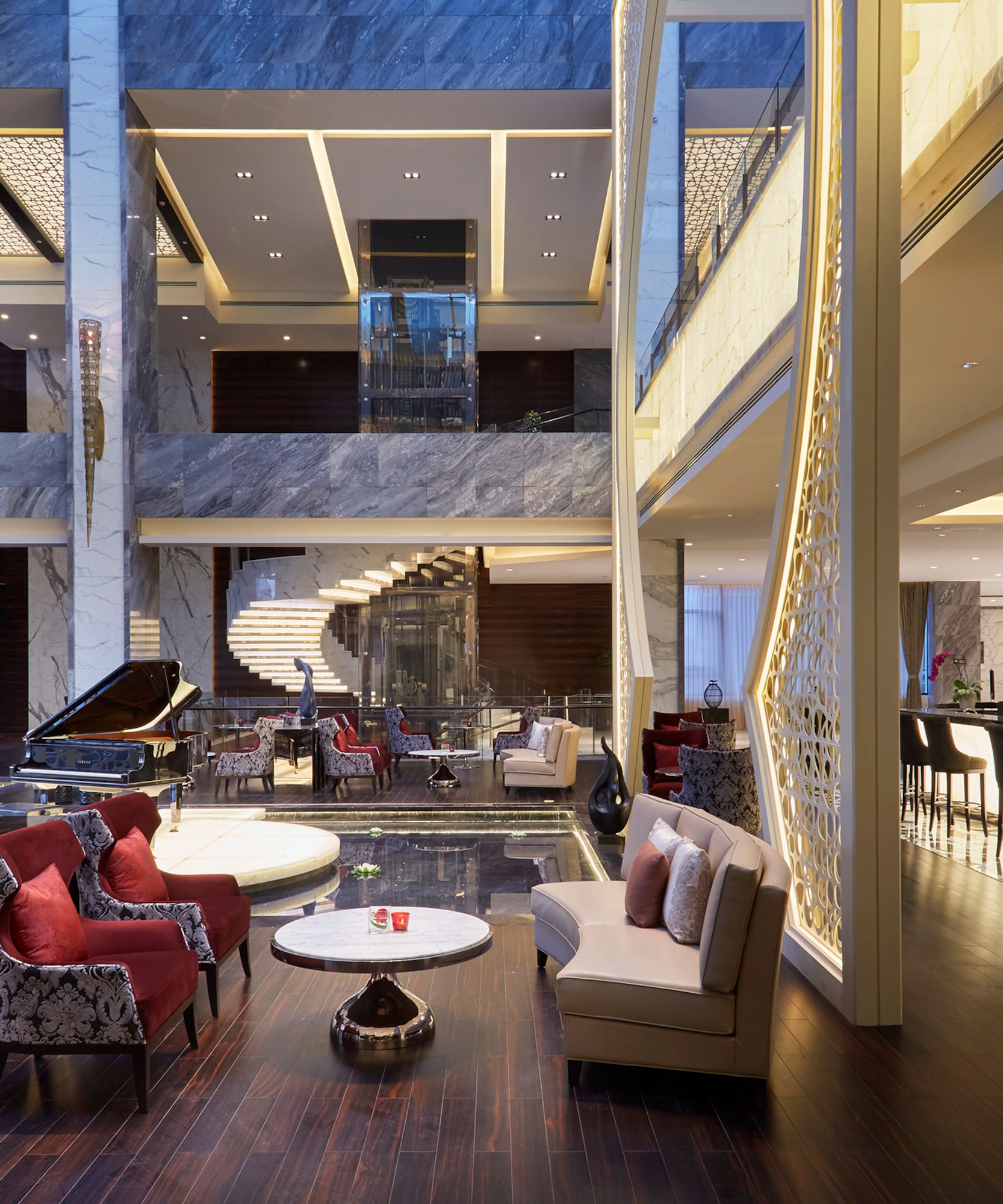 a lobby with a piano and chairs
