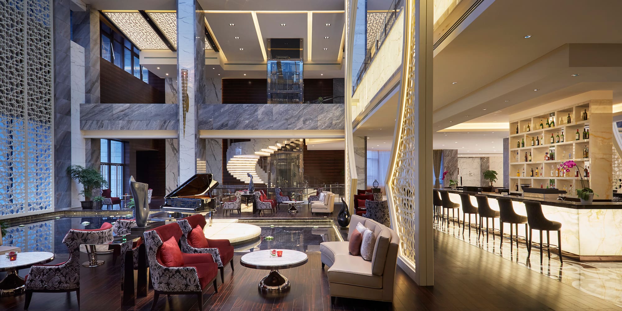 a lobby with a piano and chairs