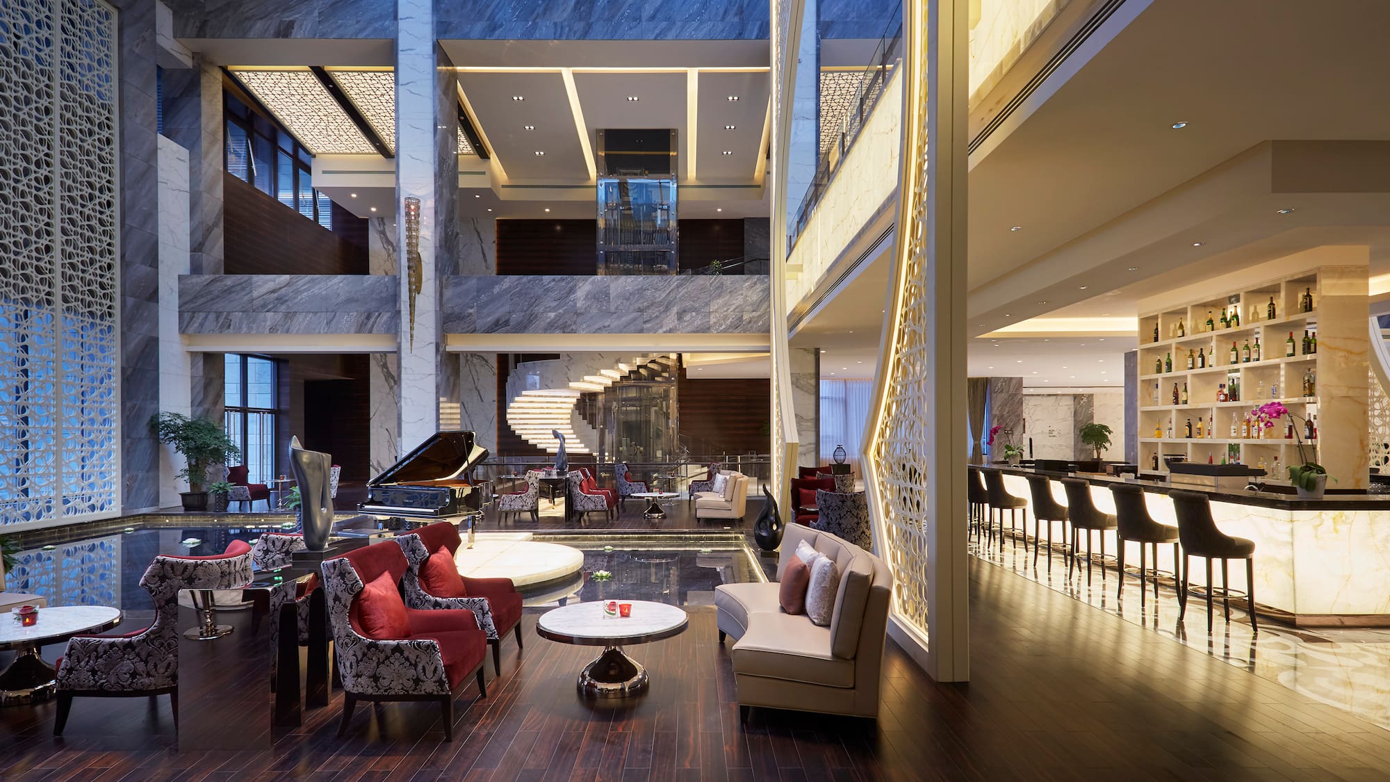 a lobby with a piano and chairs