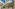 Modern resort hotel, tropical palm trees, outdoor dining terrace.