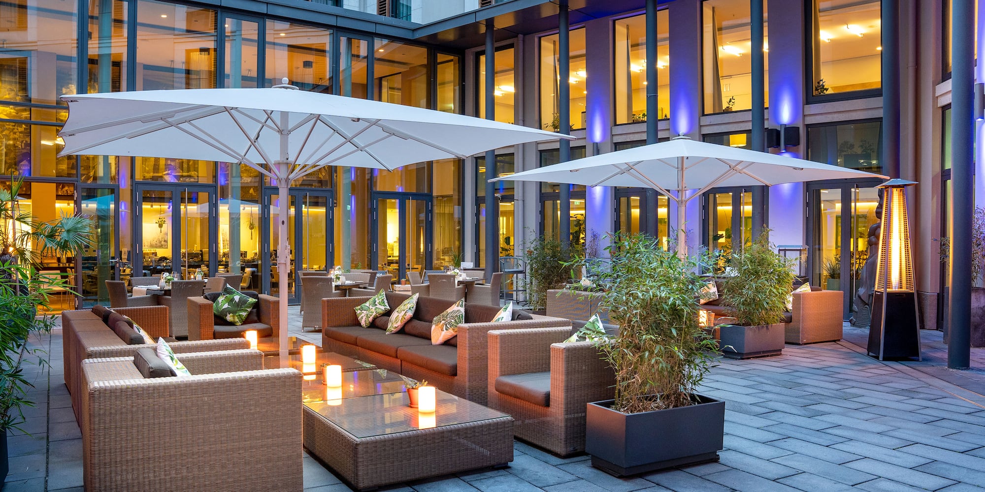 a patio area with chairs and umbrellas