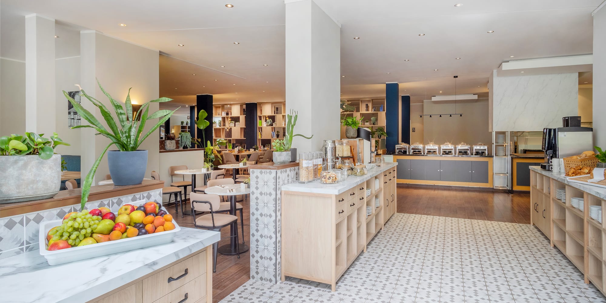a room with a large counter and tables and chairs