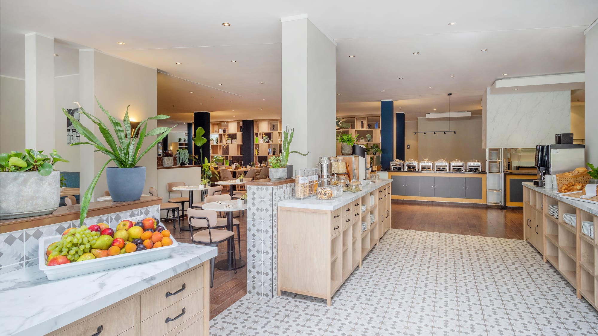 a room with a large counter and tables and chairs