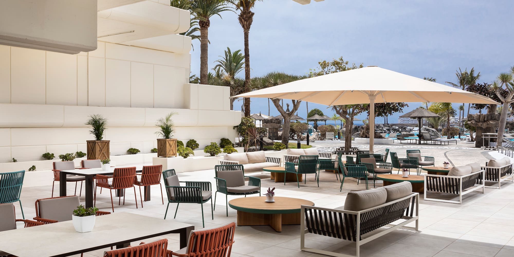 a patio area with chairs and umbrellas