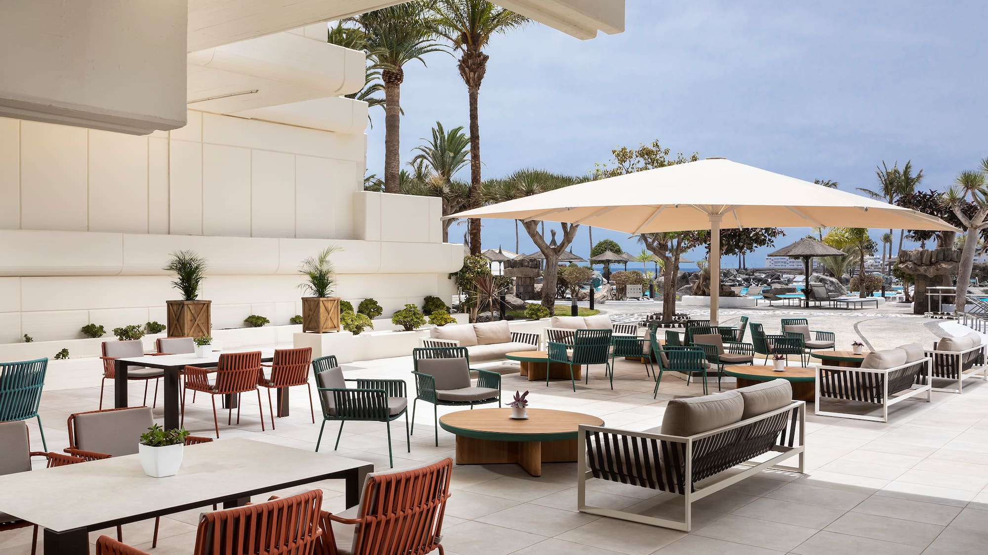 a patio area with chairs and umbrellas