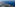 Aerial view of Mediterranean coastline, green land, coastal towns, and blue sea.