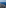 Aerial view of Mediterranean coastline, green land, coastal towns, and blue sea.