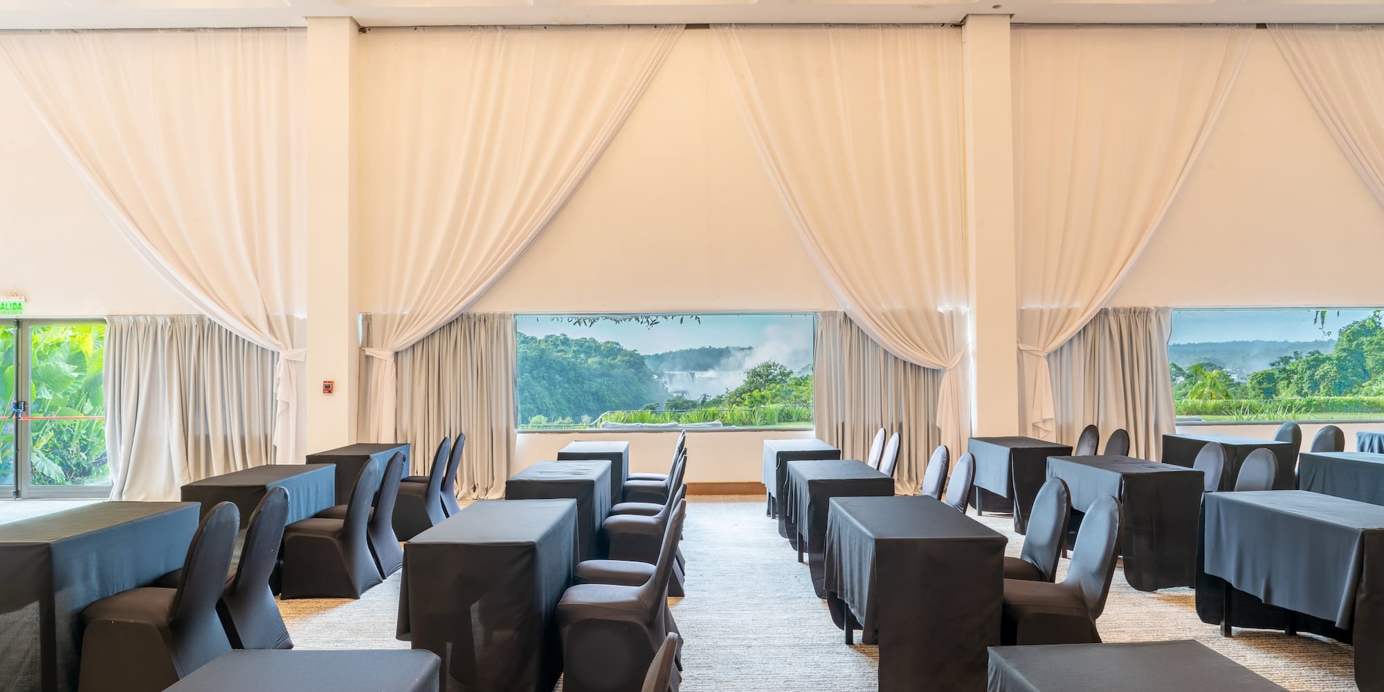 a room with black tables and chairs