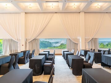 a room with black tables and chairs