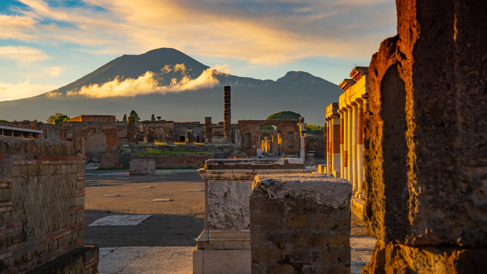 ruins of an ancient city with a mountain in the background