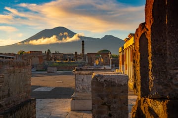 ruins of an ancient city with a mountain in the background