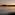 Paddleboarder on ocean at sunset, mountains silhouetted against golden sky.