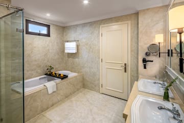 a bathroom with marble walls and a bathtub