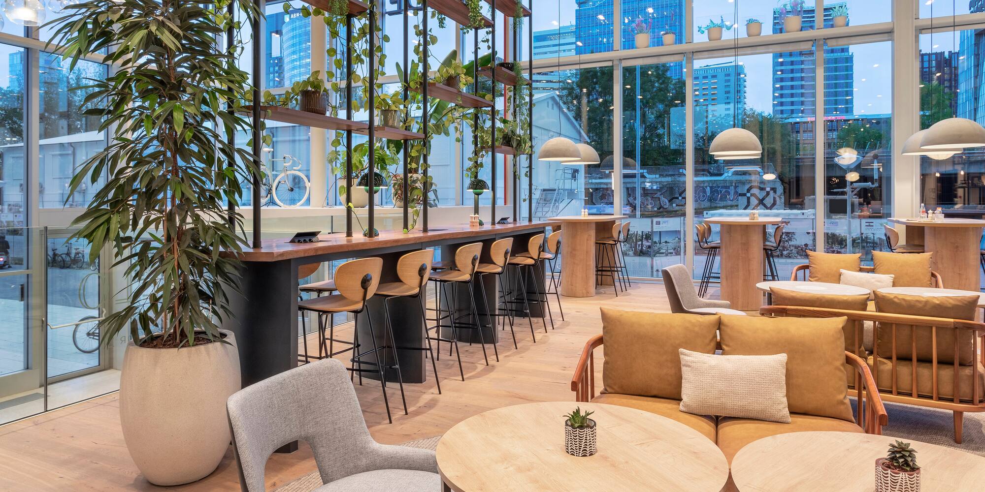 a room with tables and chairs and a large window