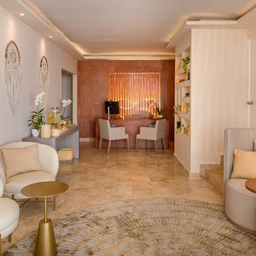 a room with a round rug and chairs