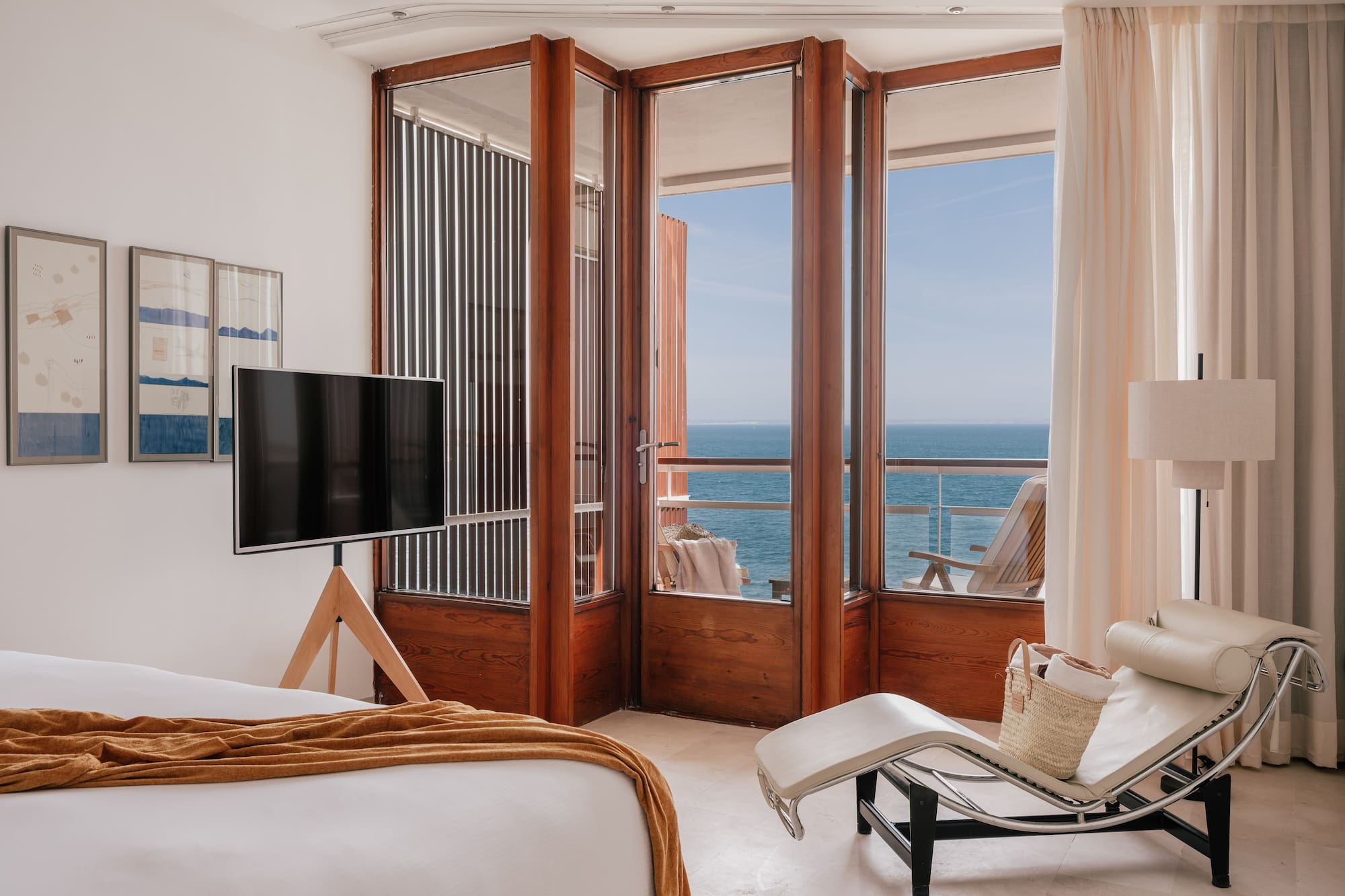 a bedroom with a television and a chair