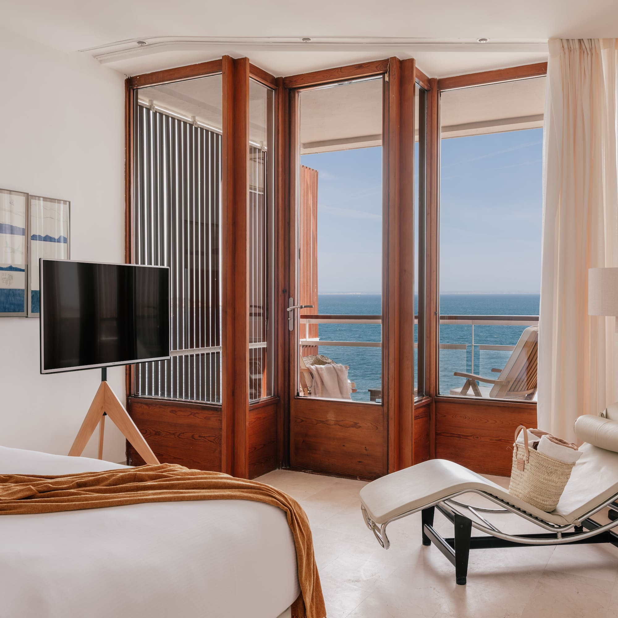 a bedroom with a television and a chair