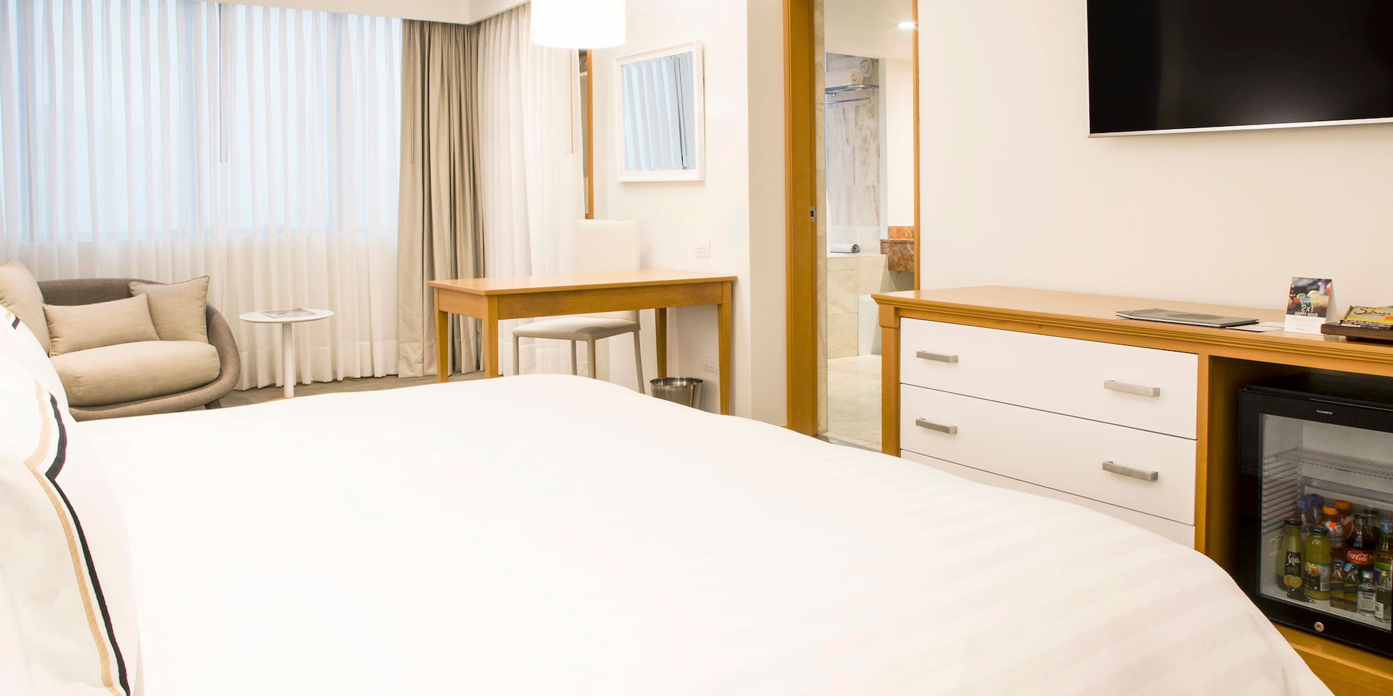 a bedroom with a tv and a bed