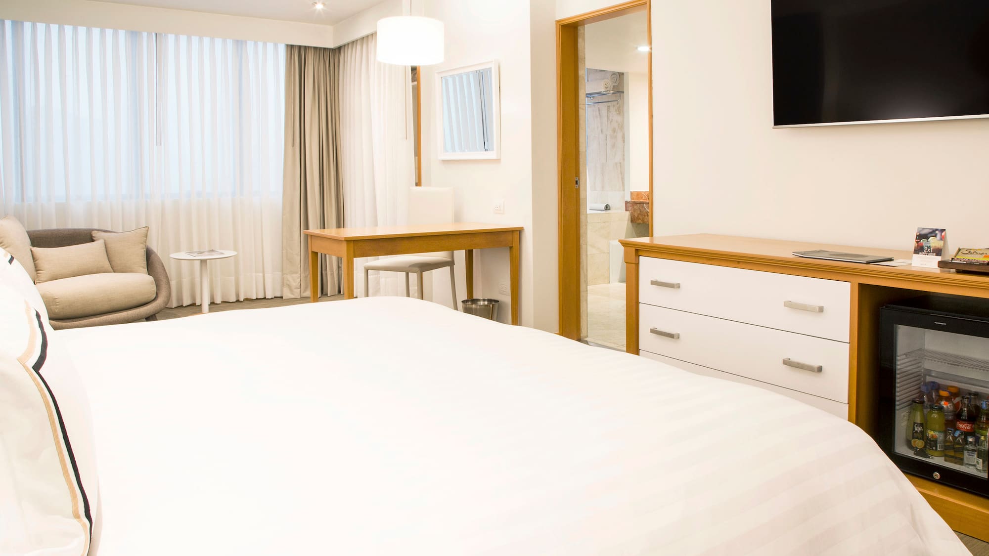 a bedroom with a tv and a bed