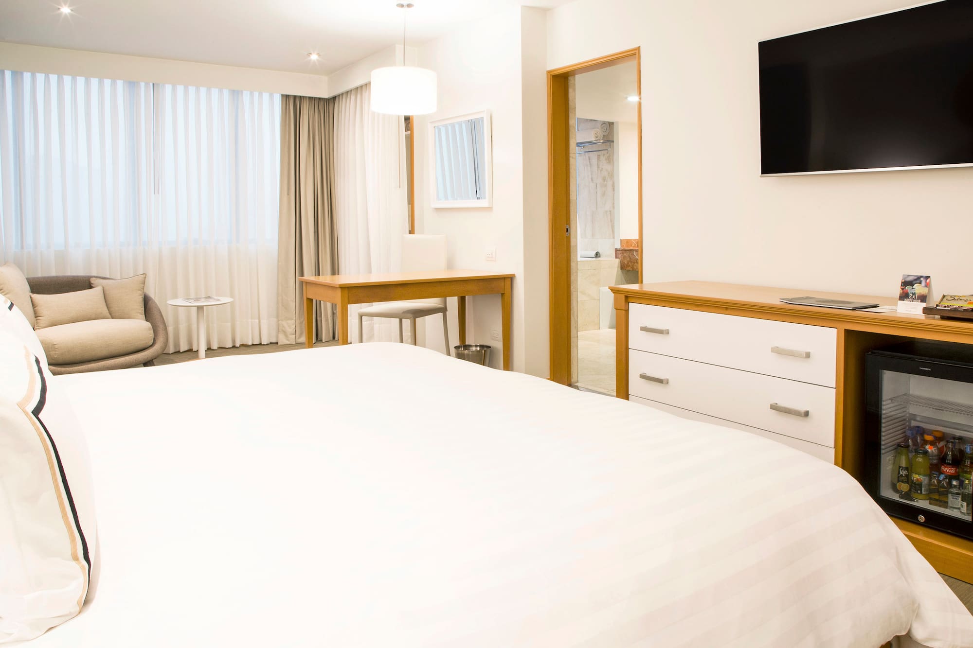 a bedroom with a tv and a bed