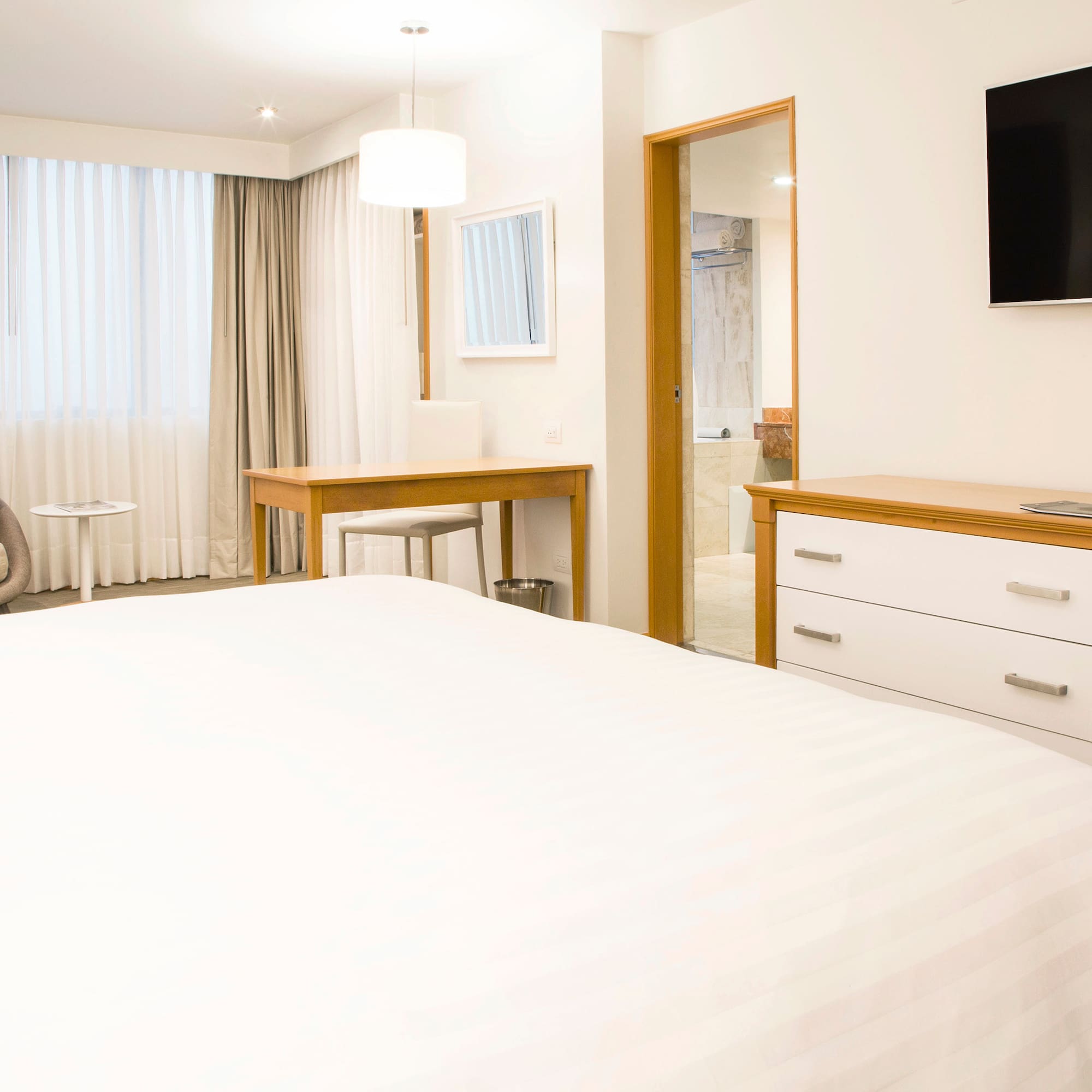 a bedroom with a tv and a bed