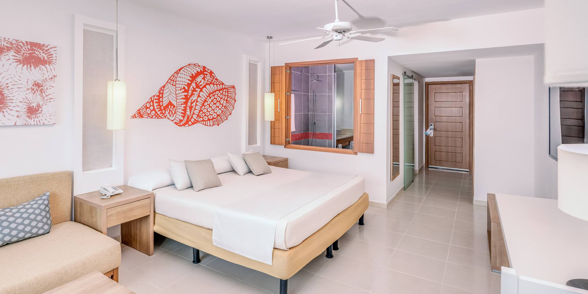 a room with a bed and a fan