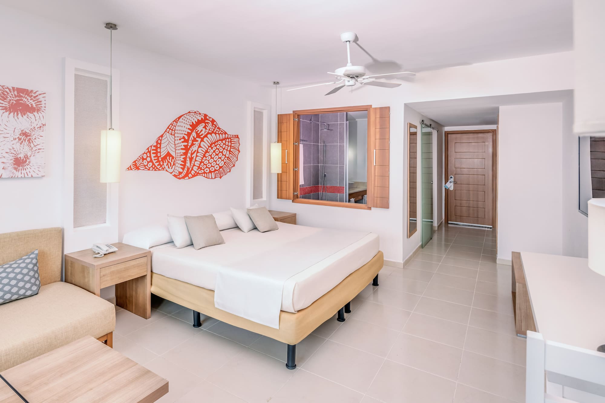 a room with a bed and a fan