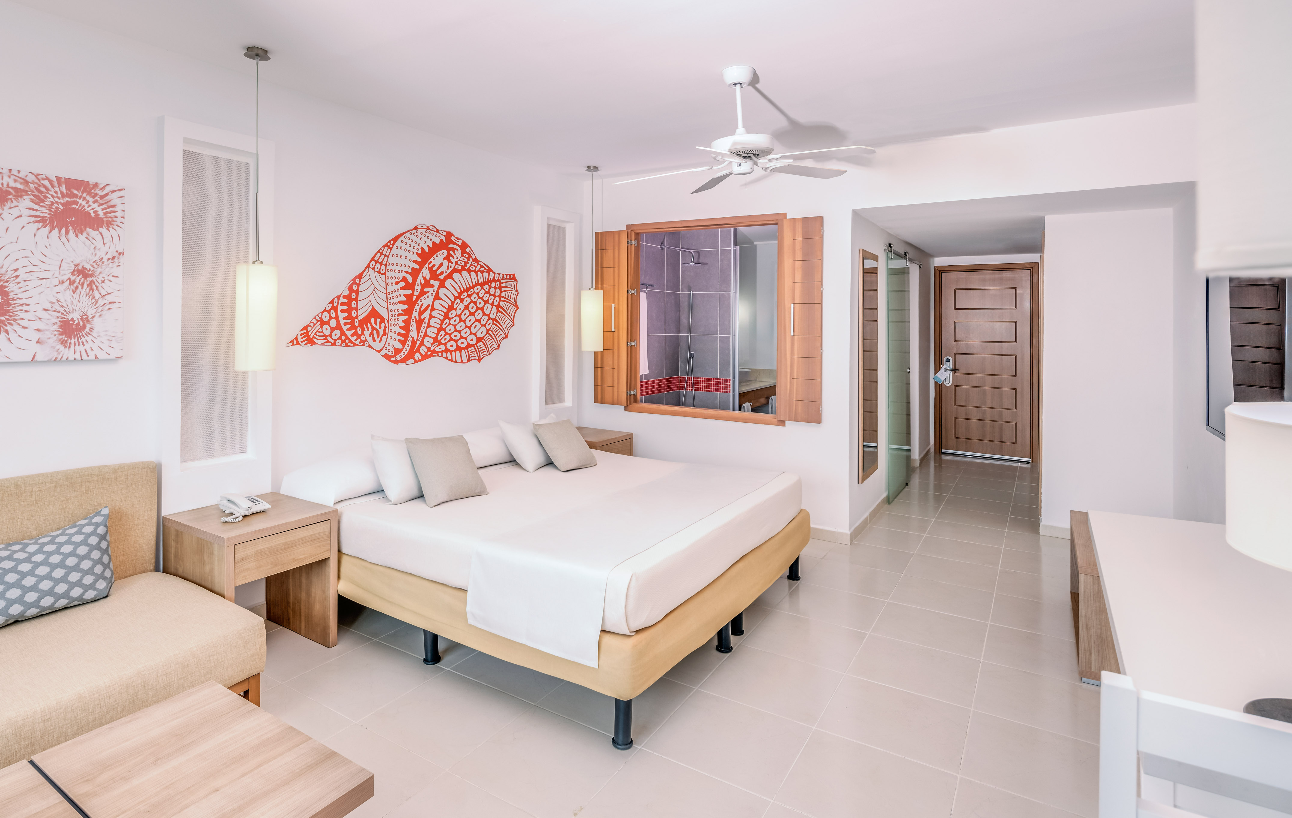 a room with a bed and a fan