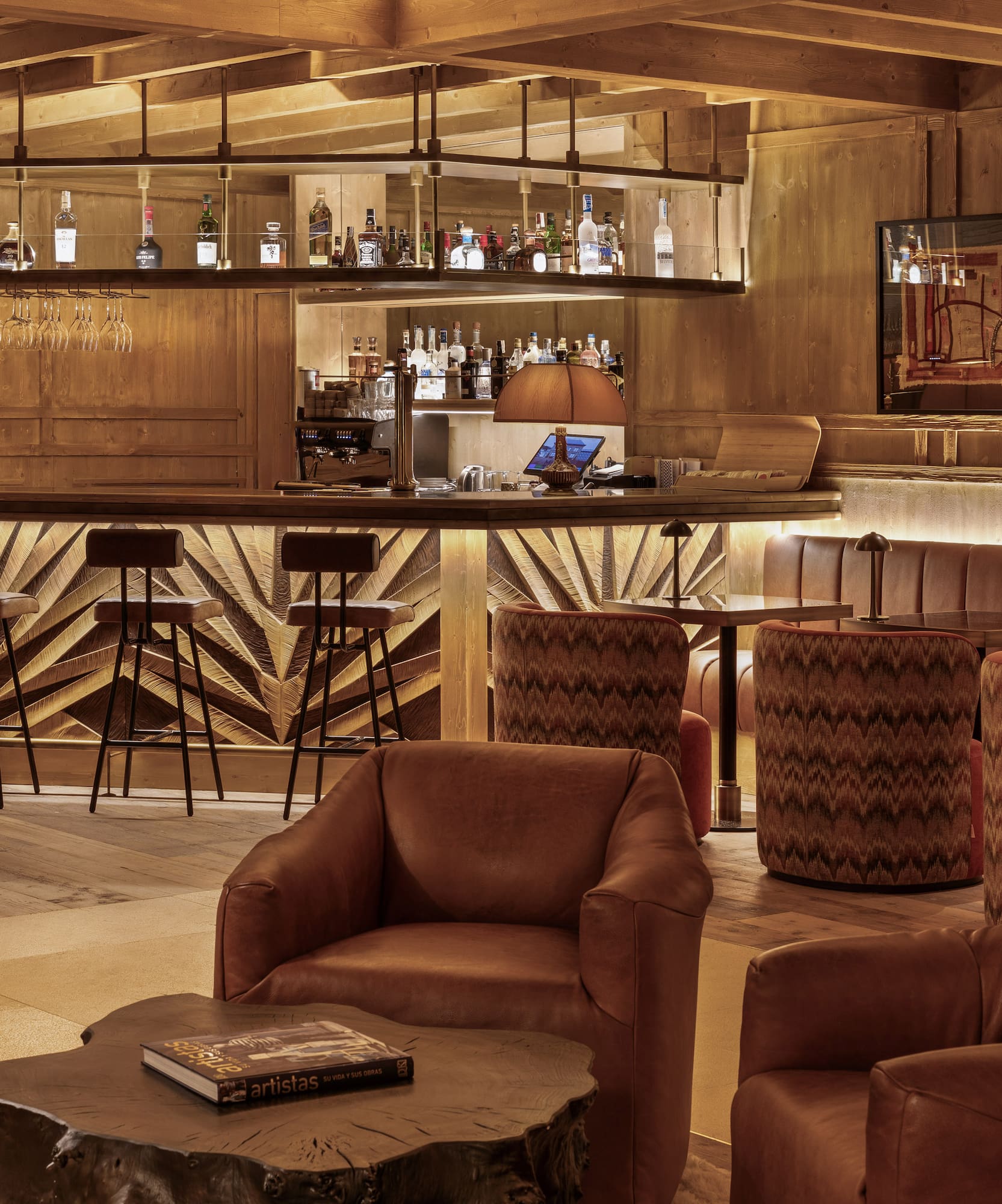 a room with a bar and chairs