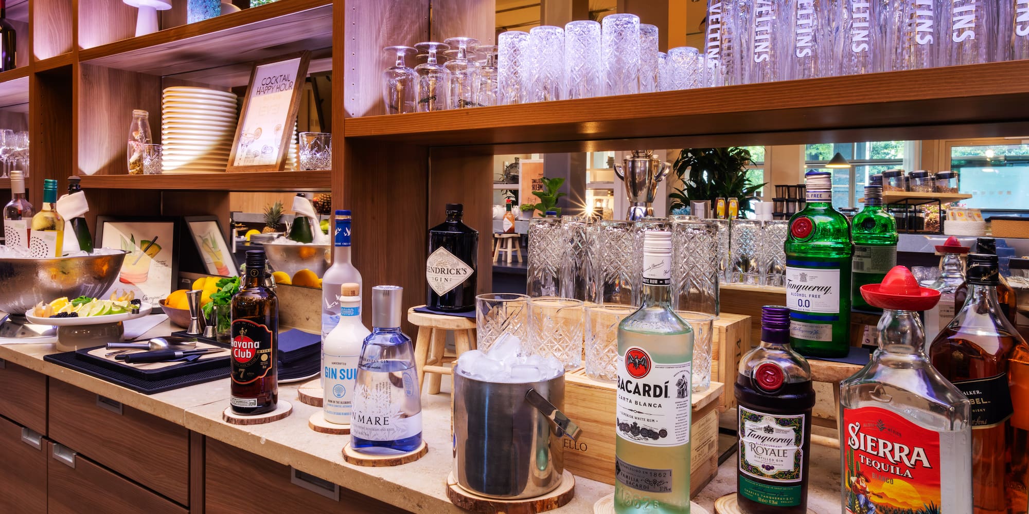 a shelf with bottles and glasses