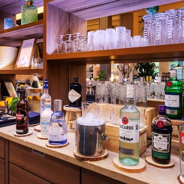 a shelf with bottles and glasses