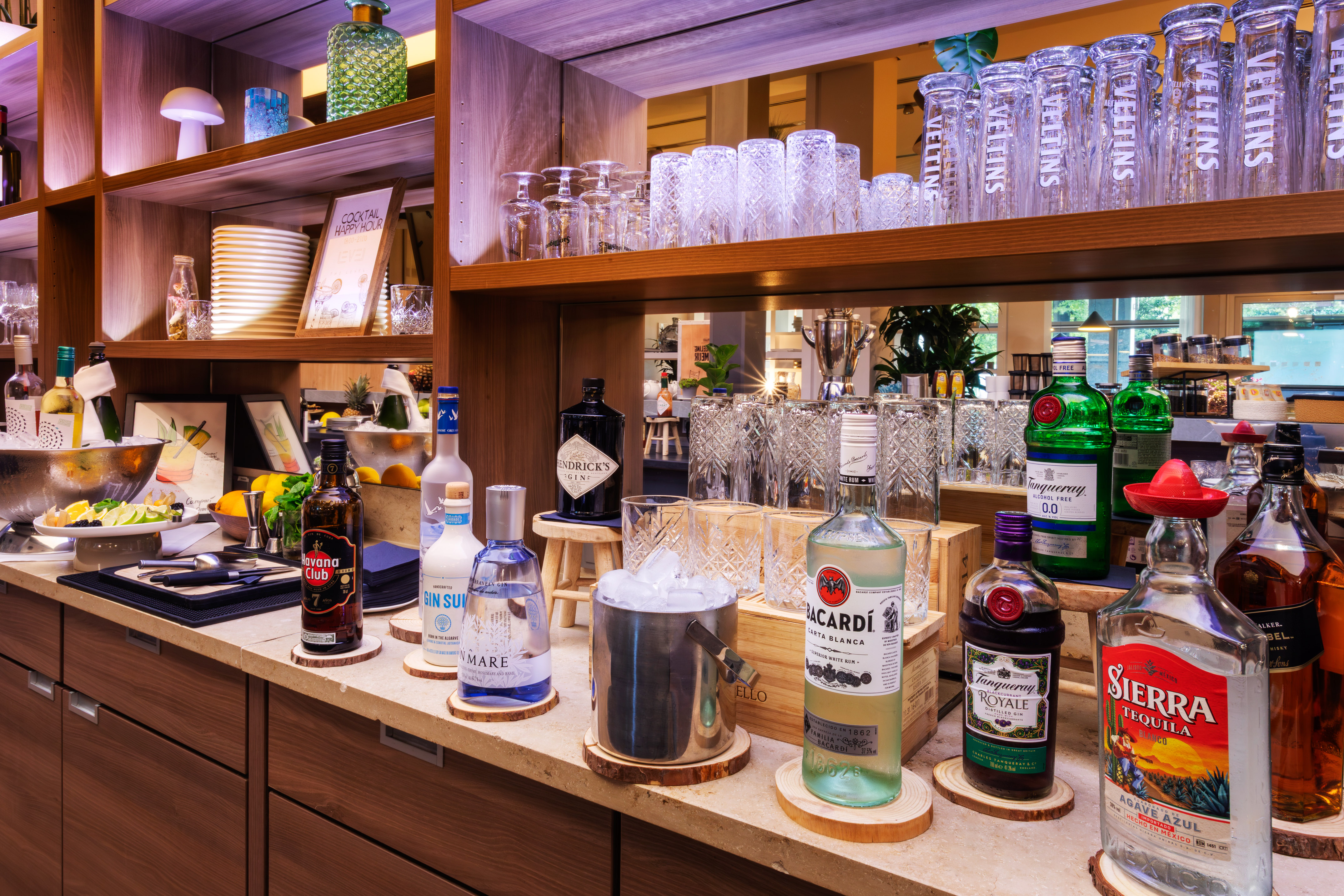 a shelf with bottles and glasses