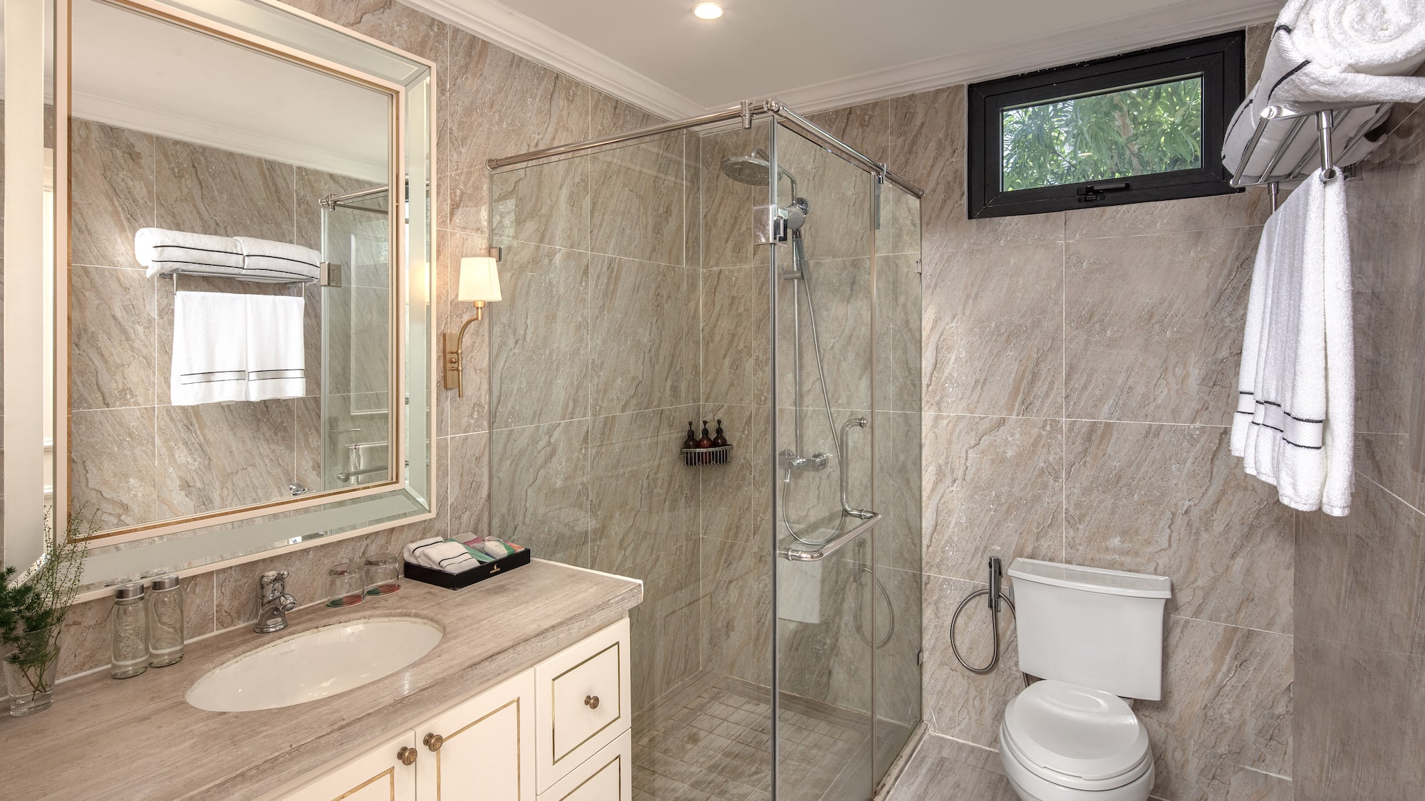 a bathroom with a glass shower and sink