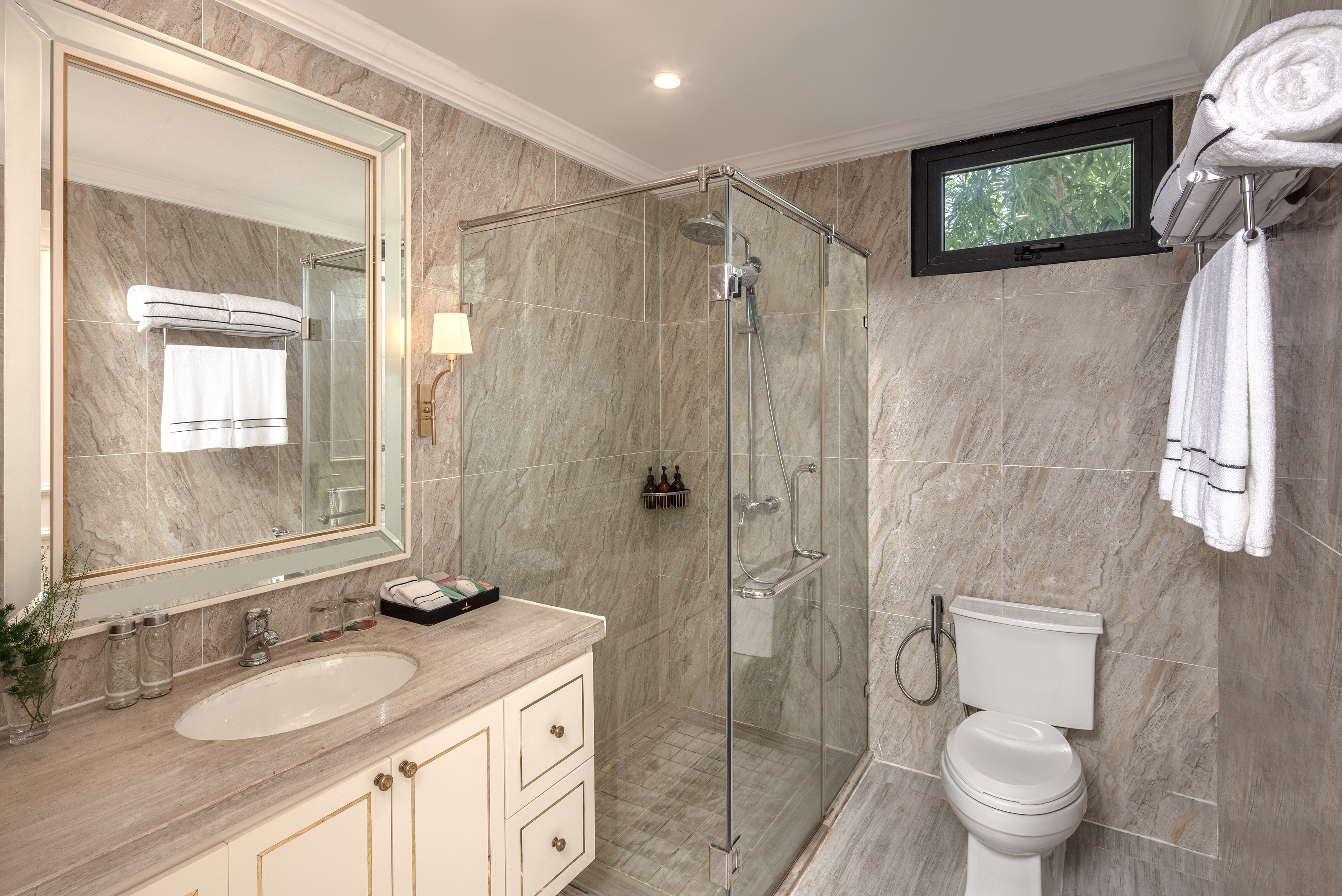 a bathroom with a glass shower and sink
