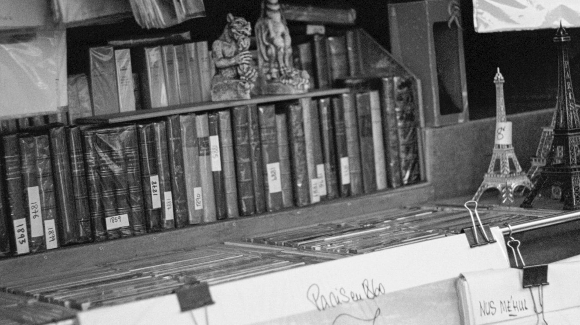 a shelf with books and a statue of eiffel tower