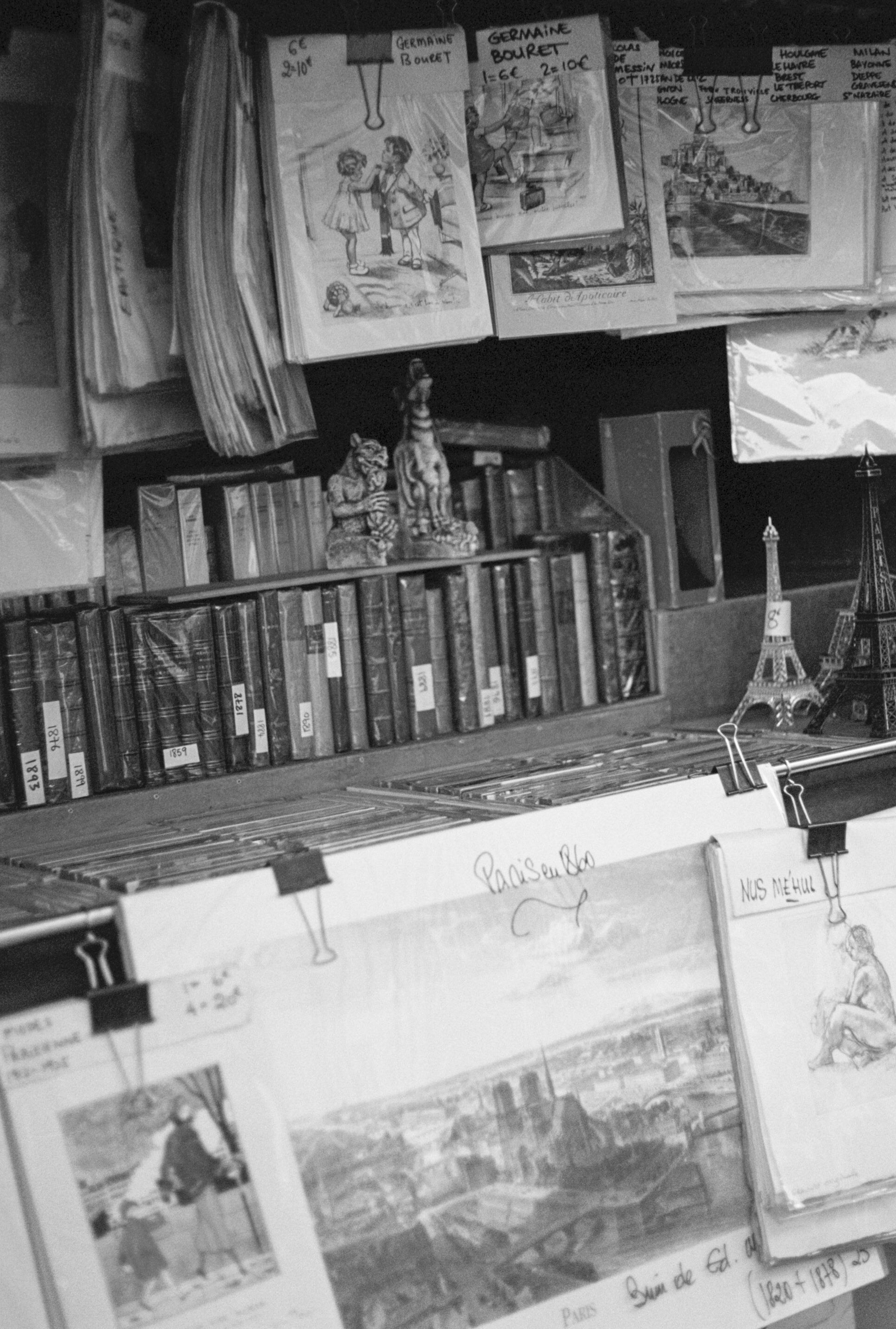 a shelf with books and a statue of eiffel tower