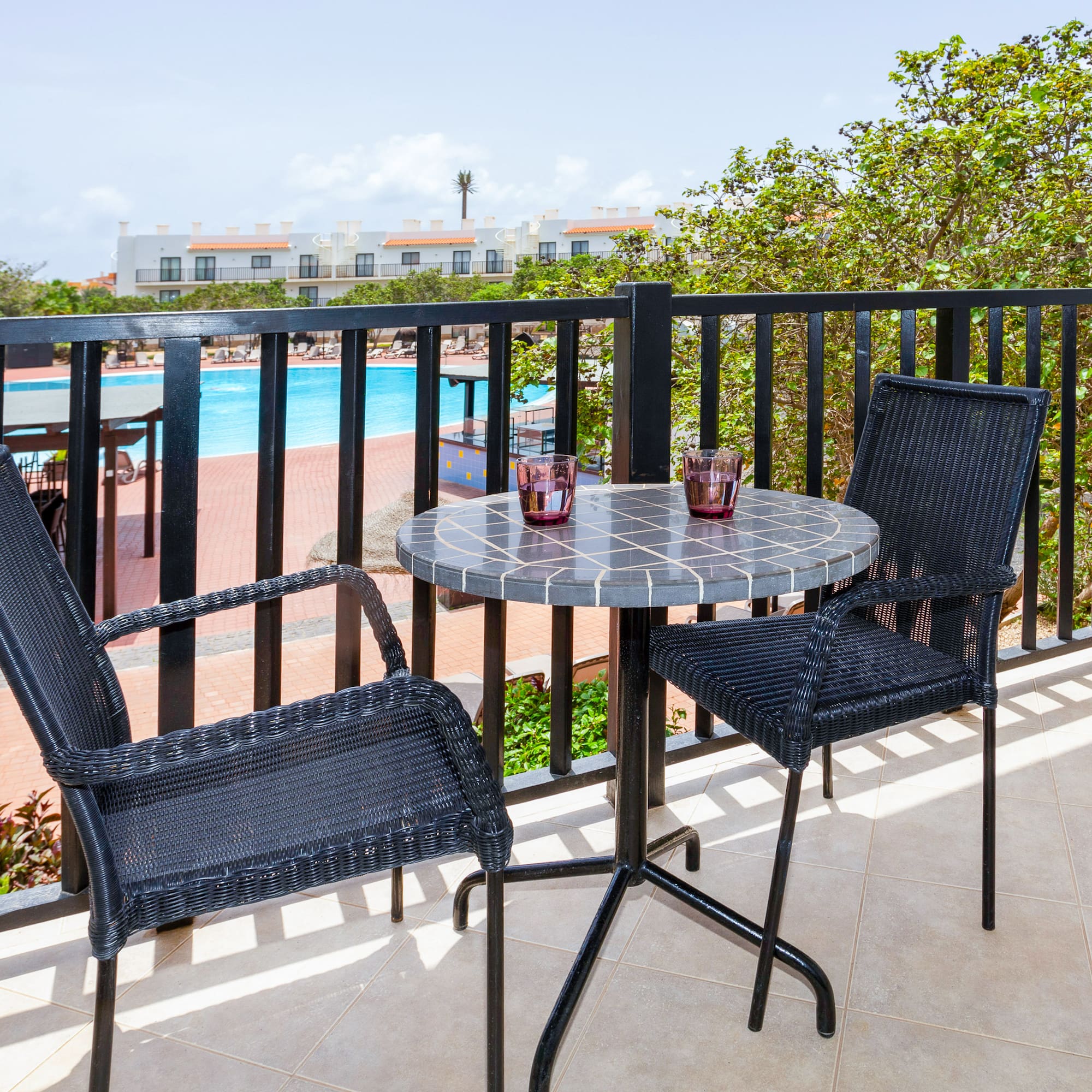 a table and chairs on a balcony