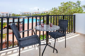 a table and chairs on a balcony