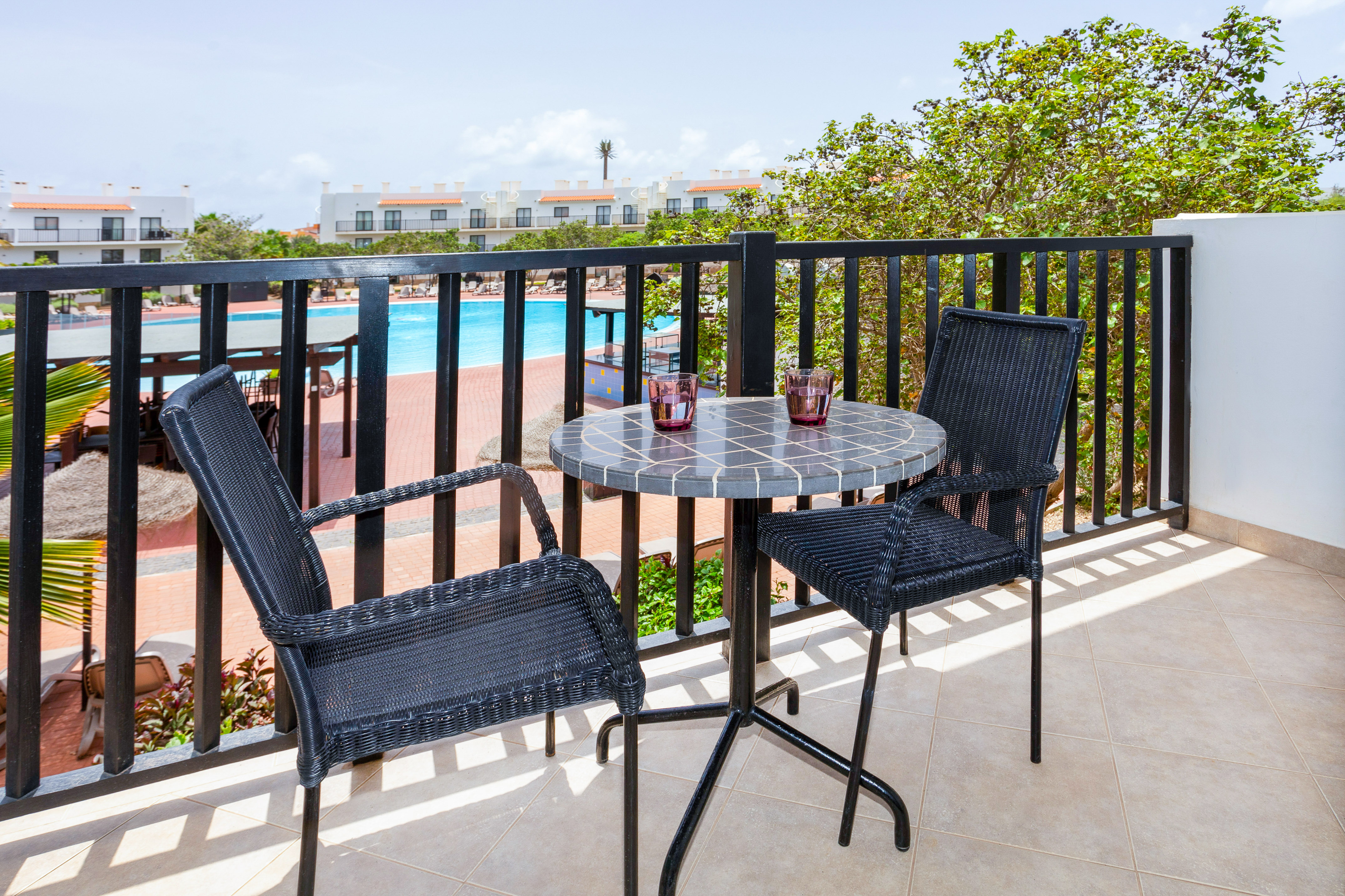 a table and chairs on a balcony