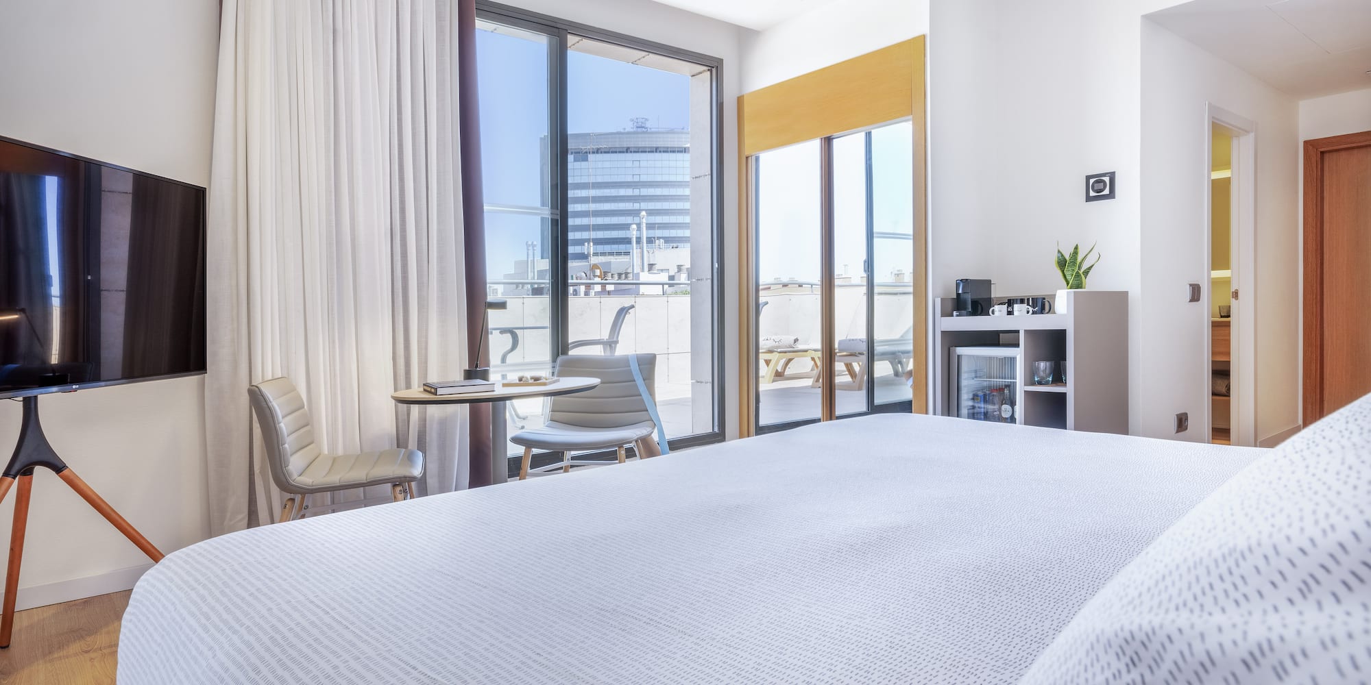 a bedroom with a bed and a table and chairs