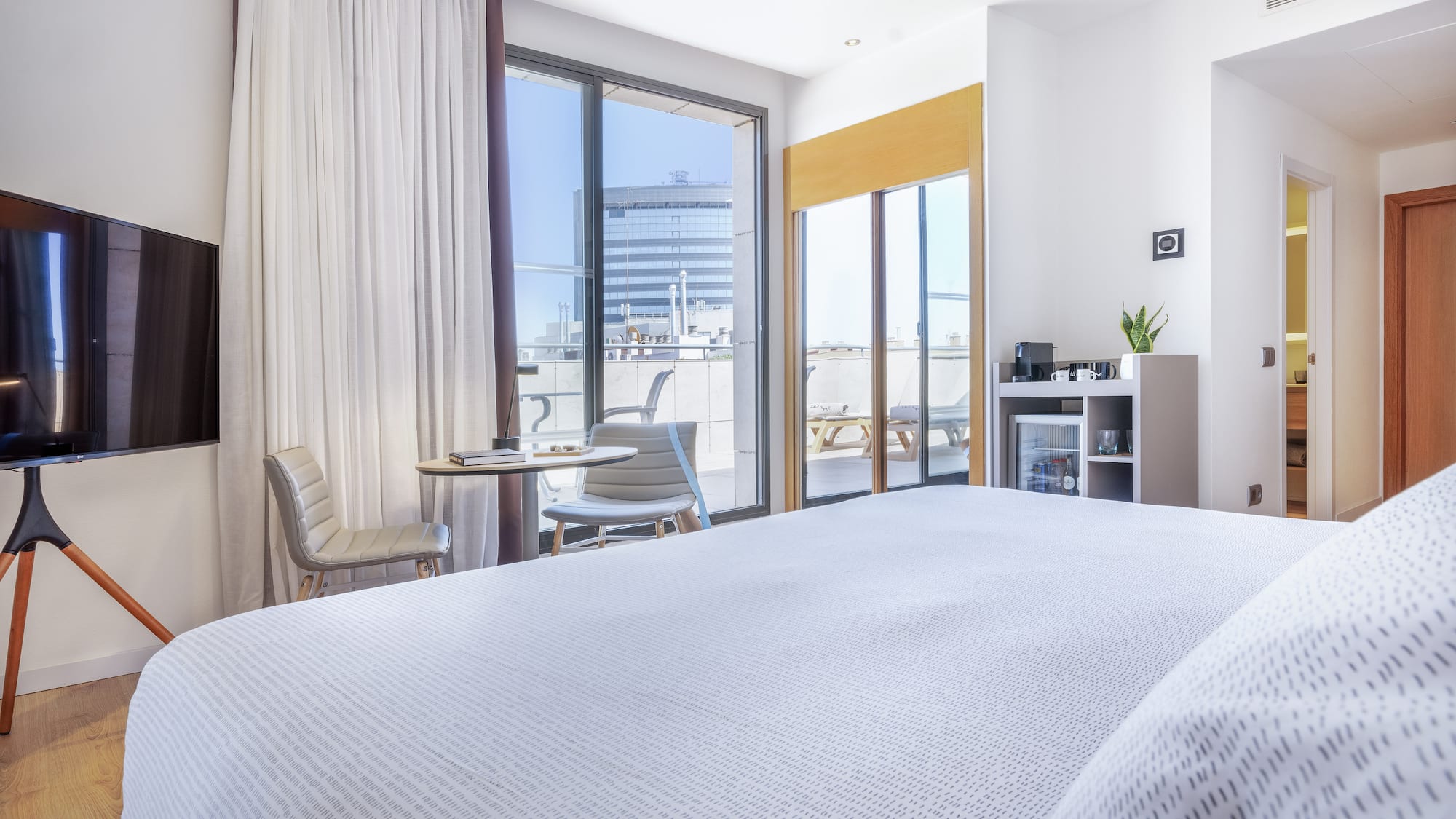 a bedroom with a bed and a table and chairs