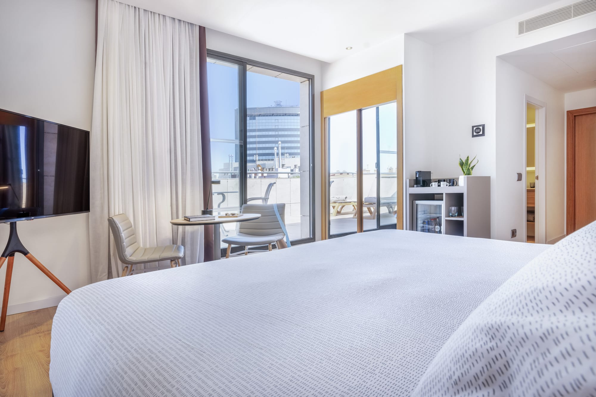 a bedroom with a bed and a table and chairs