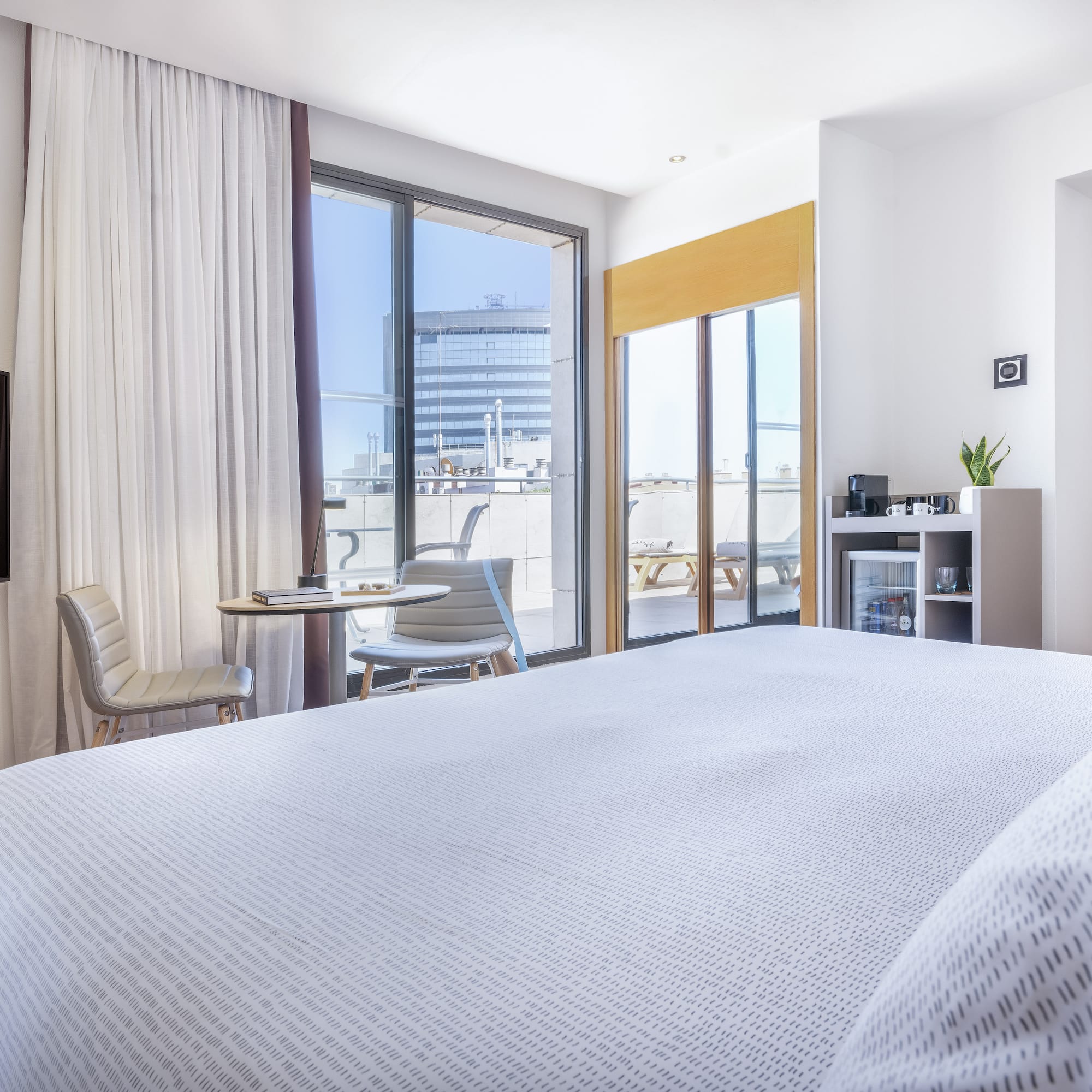 a bedroom with a bed and a table and chairs