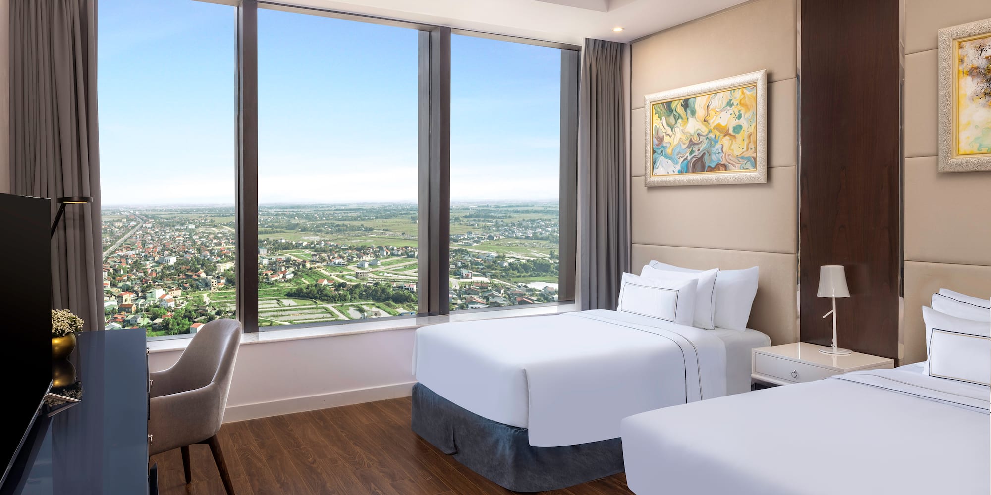 a room with two beds and a chair and a large window