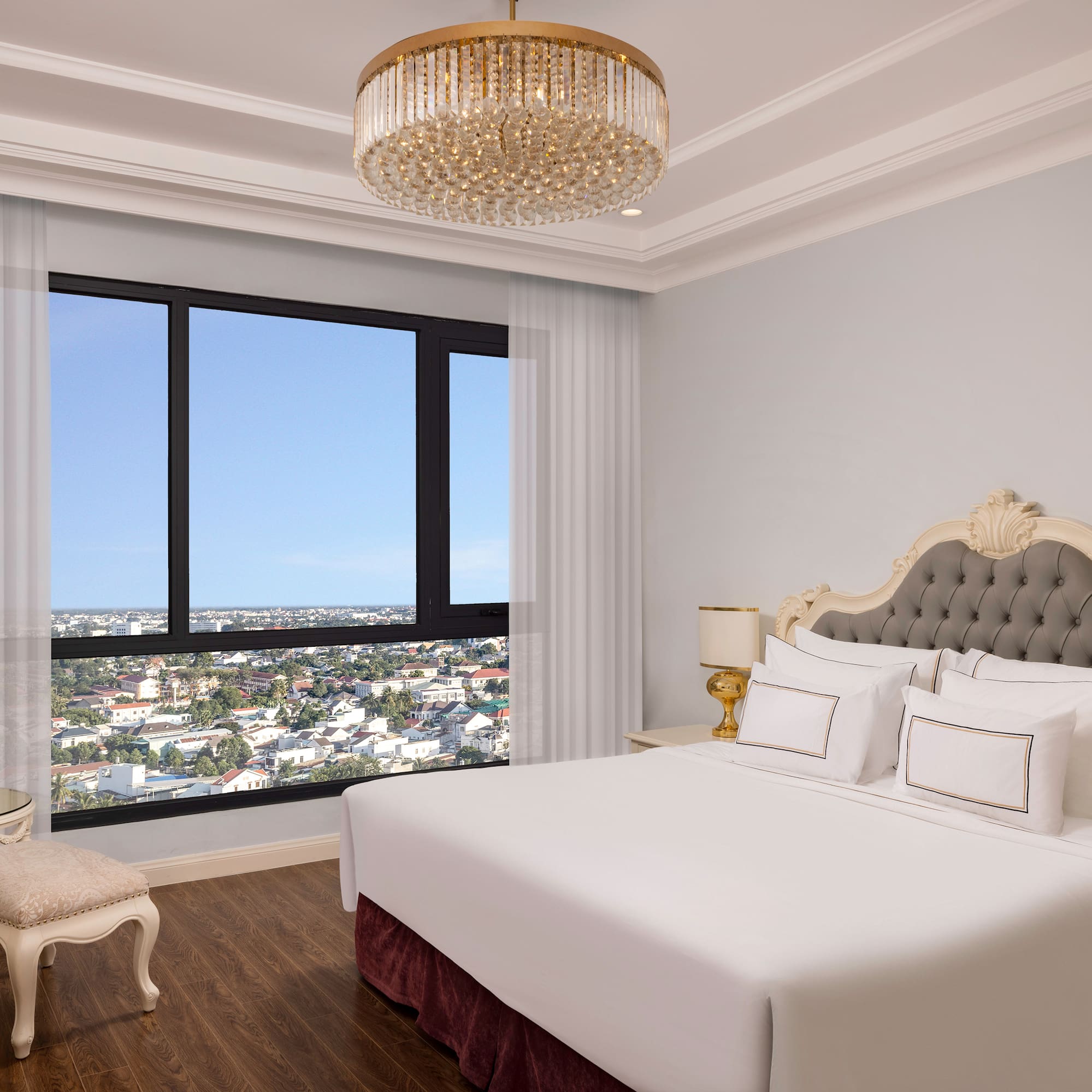 a bedroom with a large window and a large bed