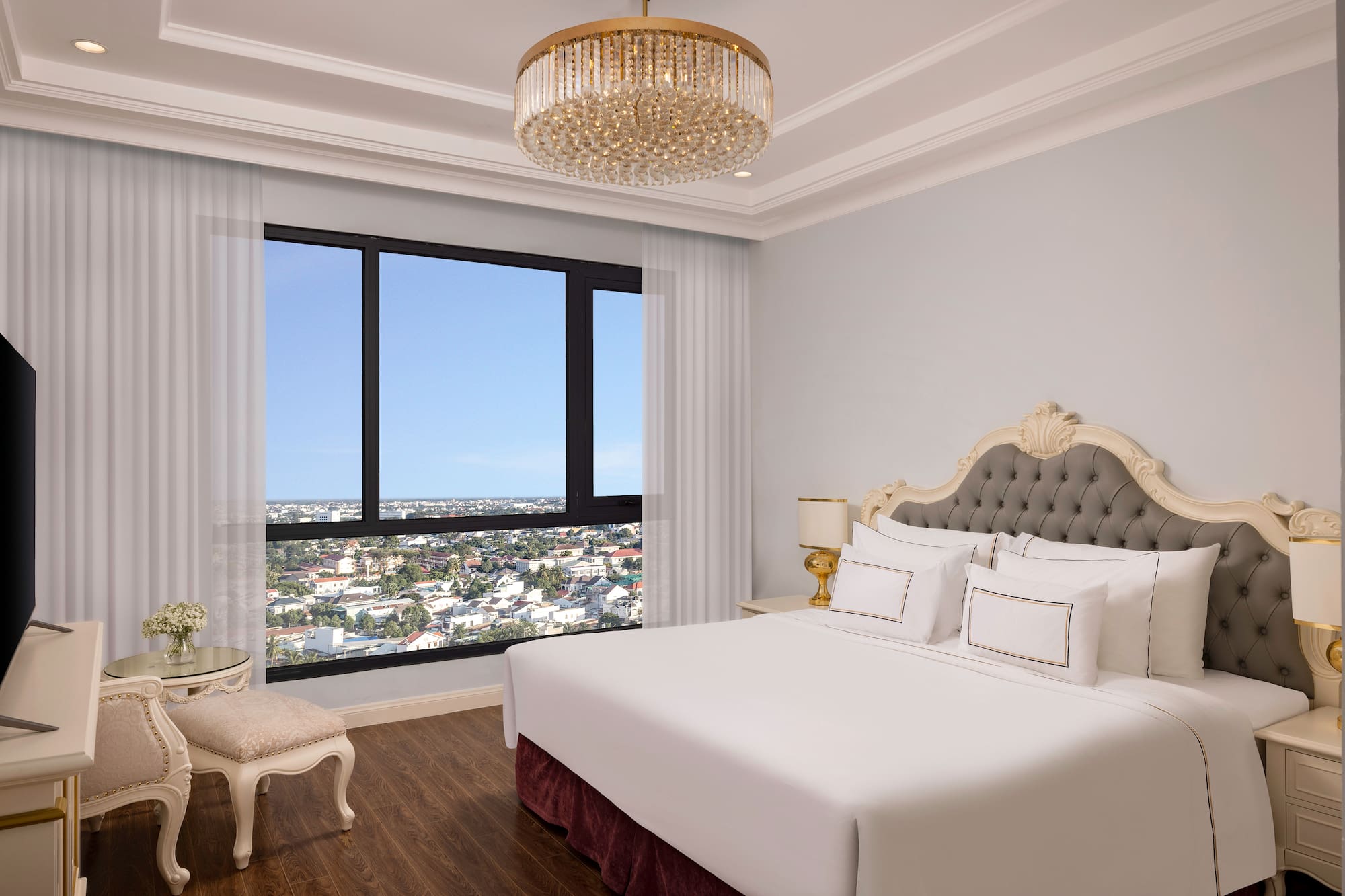 a bedroom with a large window and a large bed